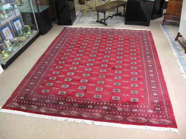 Appraisal: Hand knotted Bokhara rug Measures ' x ' Maroon color