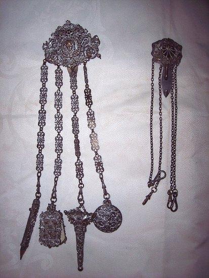 Appraisal: A chatelaine with embossed clip and mounts having pierced links