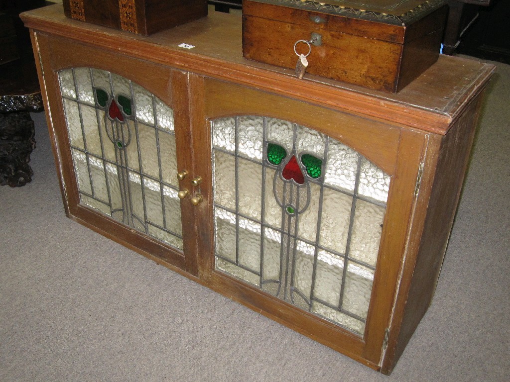 Appraisal: Stained and leaded glazed door wall mounted cabinet attributed to