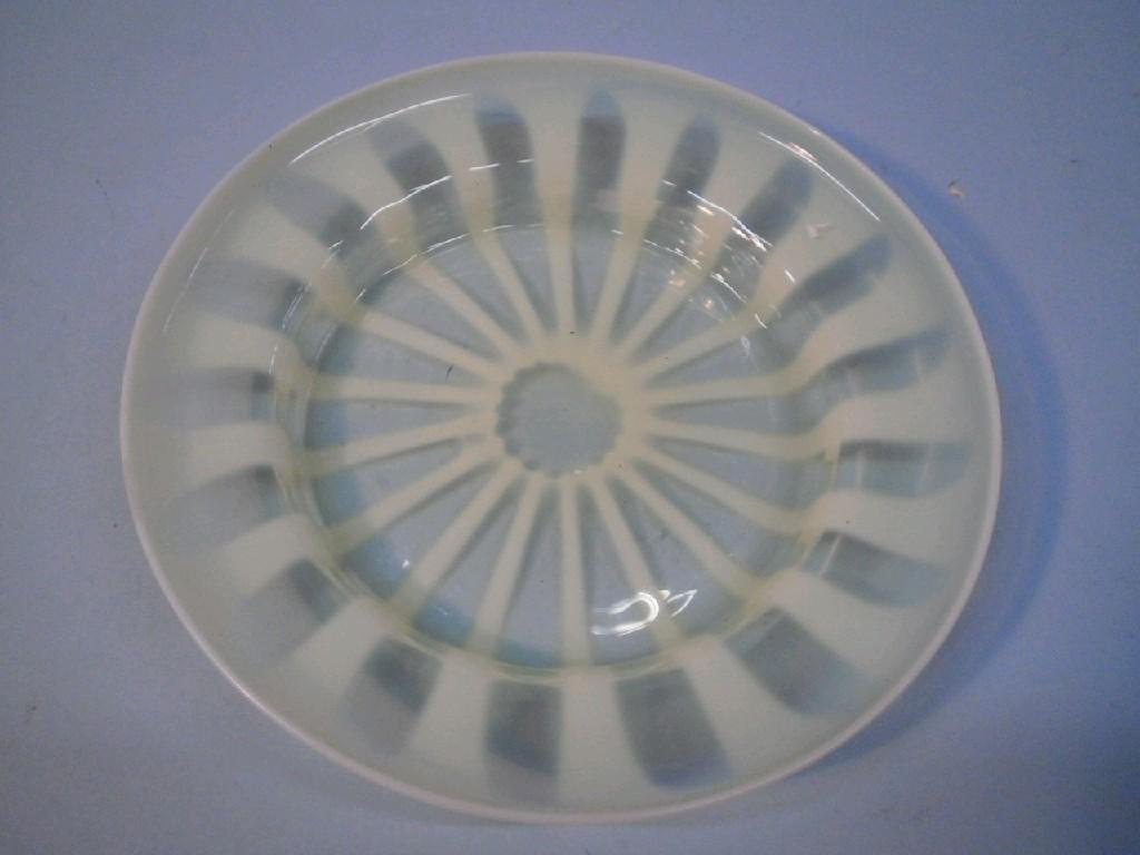 Appraisal: A Victorian Vaseline glass plate with stylised sunburst type decoration