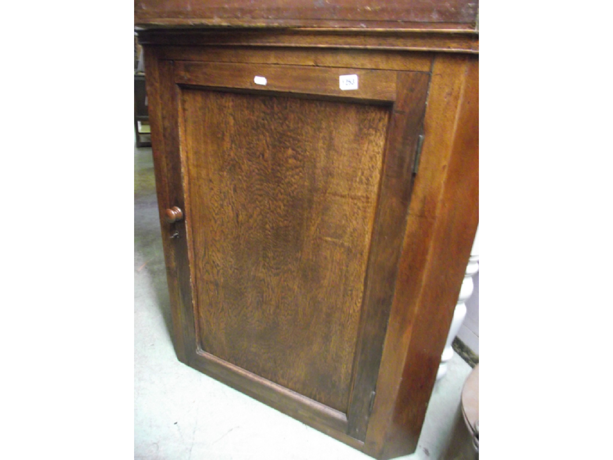 Appraisal: A Georgian oak wall hanging corner cupboard enclosed by a