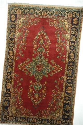 Appraisal: A KASHAN RED GROUND RUG decorated a central foliate medallion