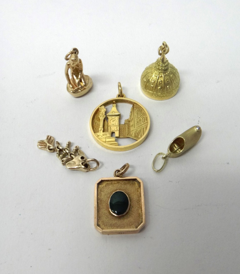 Appraisal: A gold pendant pierced with a clock tower scene detailed