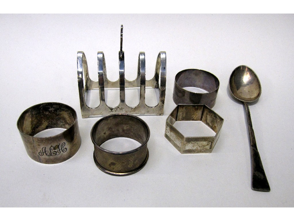 Appraisal: Lot comprising four silver napkin rings a silver spoon and