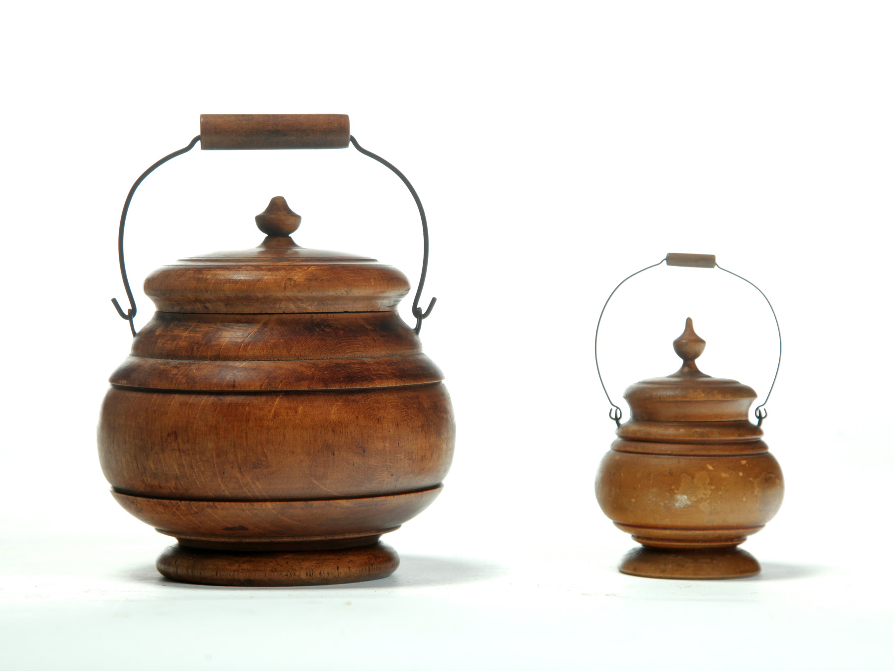 Appraisal: TWO COVERED PEASEWARE JARS Late th century Bale handles Larger