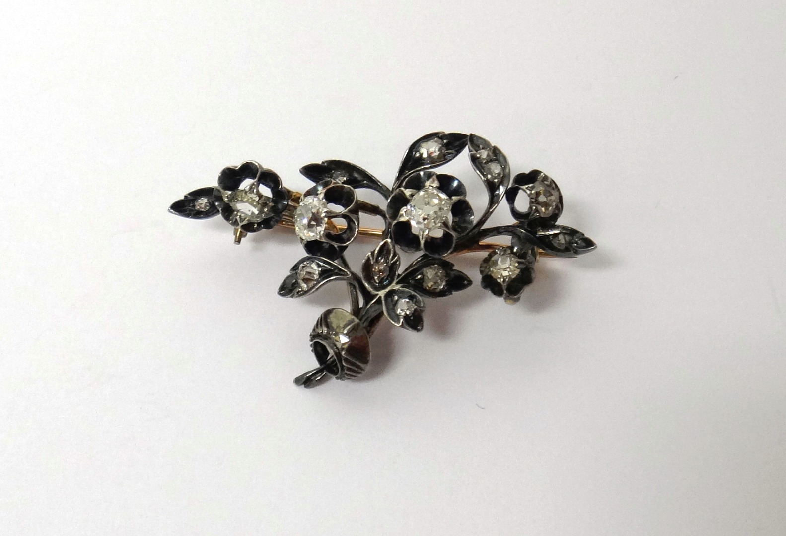 Appraisal: A diamond set brooch designed as a spray mounted with