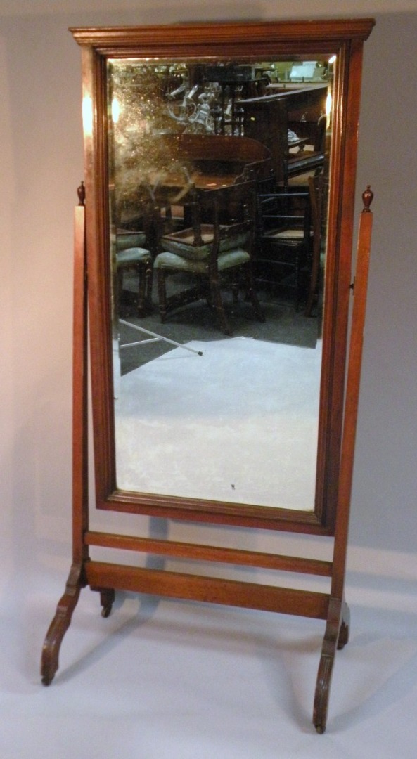 Appraisal: An Edwardian mahogany cheval mirror the rectangular bevelled glass in