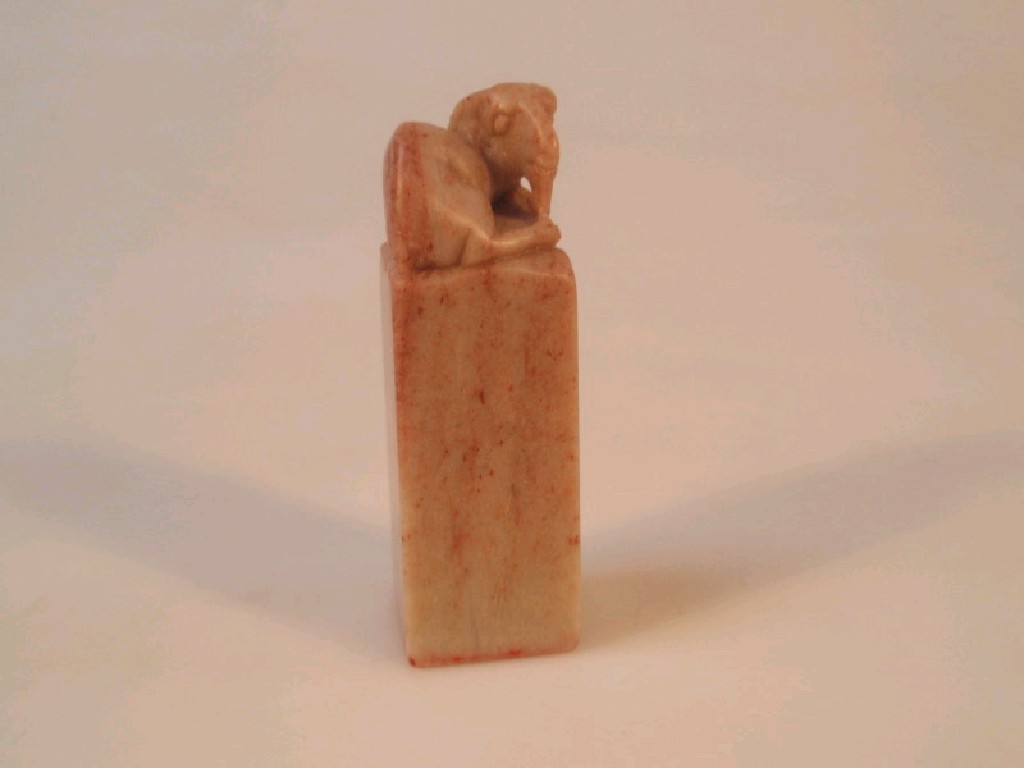 Appraisal: A Chinese carved soapstone desk seal mounted with a goat