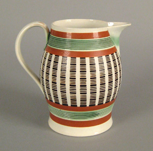 Appraisal: Mocha ovoid pitcher ca with green brown and orange stripe