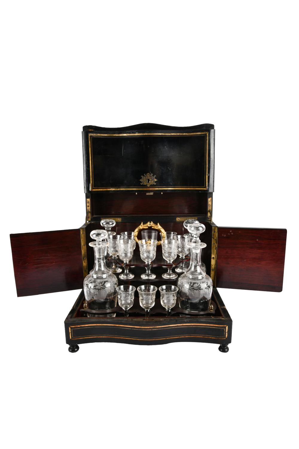 Appraisal: BRASS-INLAID EBONIZED WOOD TANTALUScontaining four bottles with stoppers and eleven