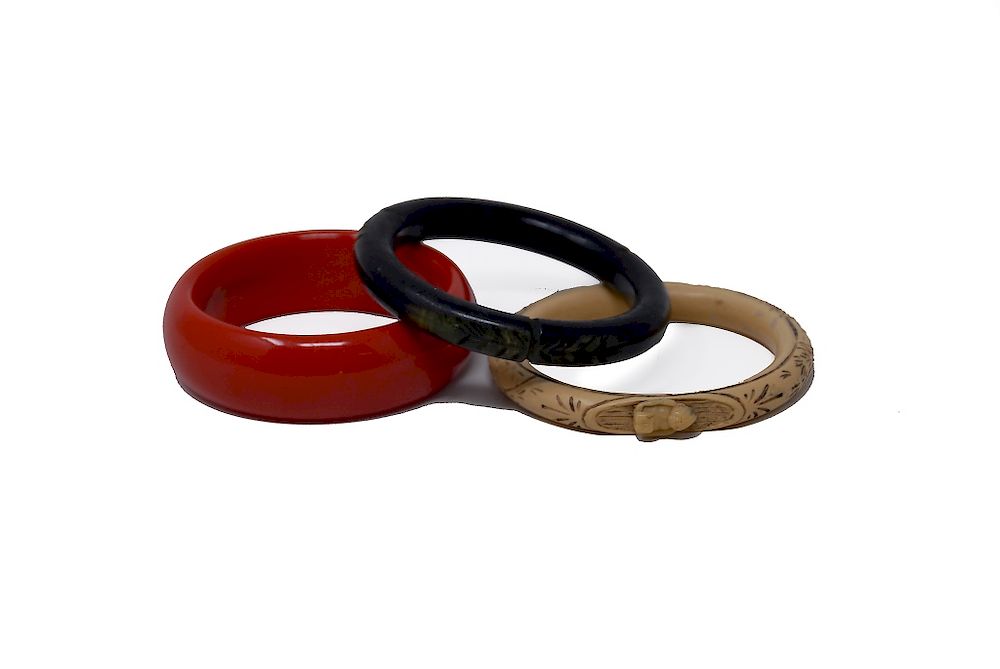 Appraisal: Bakelite Bracelets Cherry Red Carved Black Carved Bakelite Bracelets Cherry