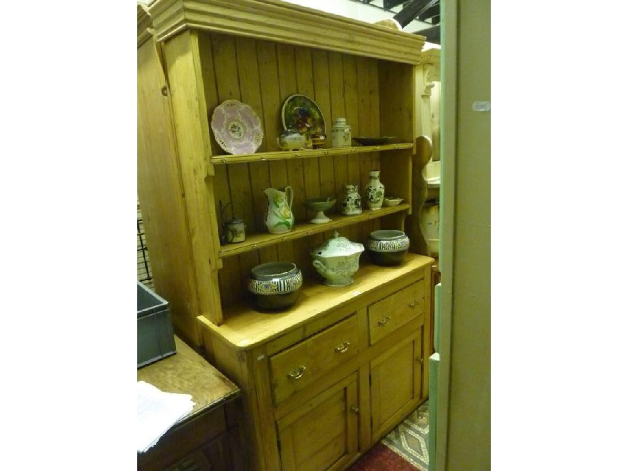 Appraisal: A reclaimed stripped pine kitchen dresser with two tier open