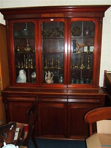 Appraisal: A Victorian mahogany triple fronted bookcase the top with central