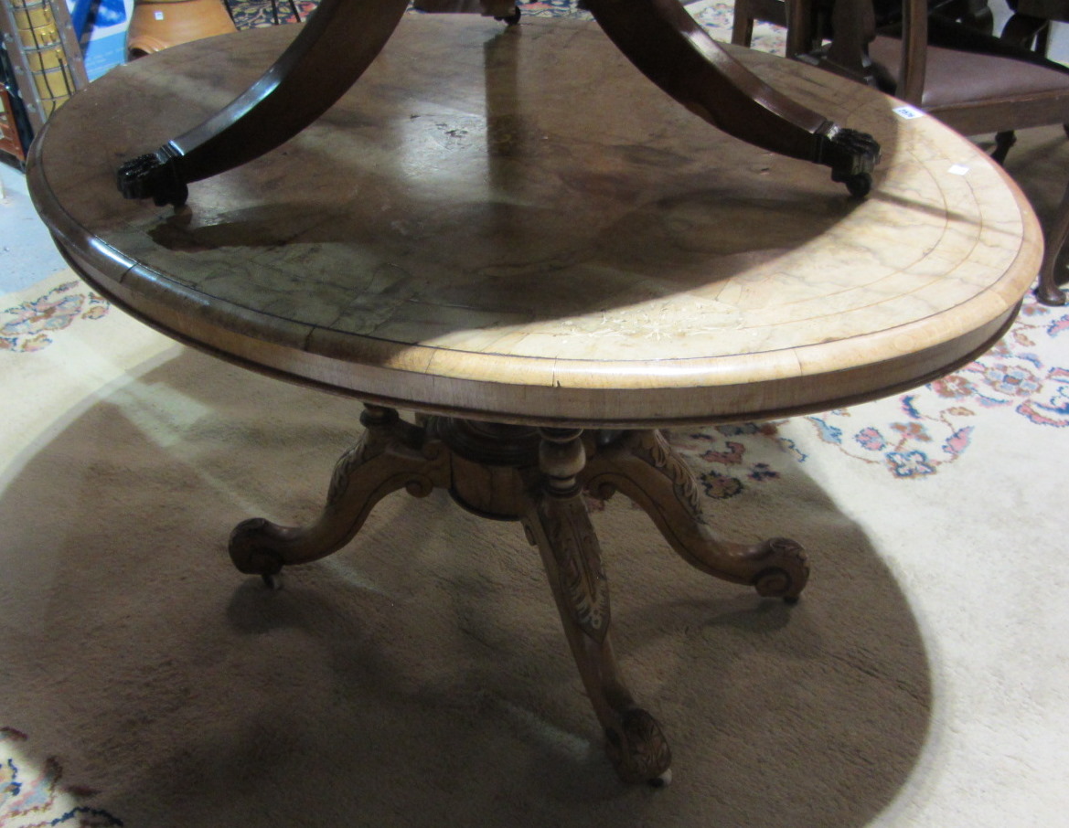 Appraisal: A th century walnut oval inlaid table