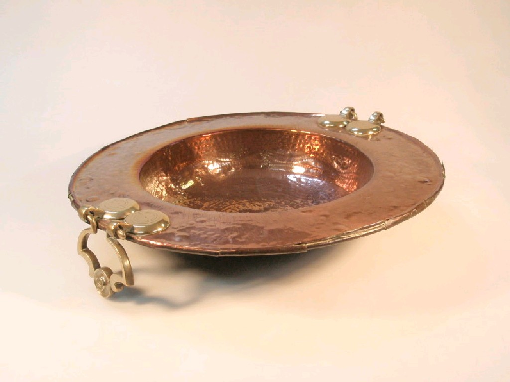 Appraisal: A large Spanish copper paella dish with brass loop handles