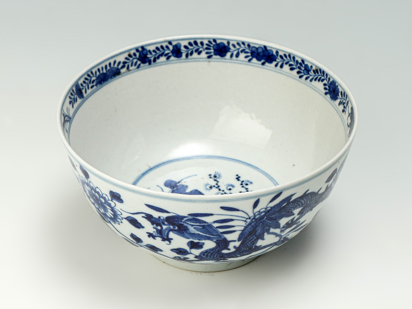 Appraisal: BLUE AND WHITE CHINESE PORCELAIN DRAGON BOWL Encompassing - toed