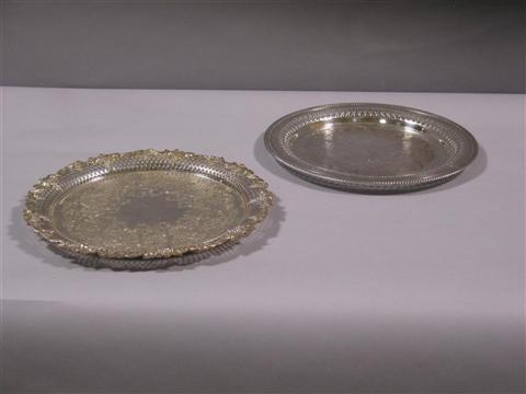 Appraisal: TWO CIRCULAR SILVER PLATED SALVERS The first with chased scrolling