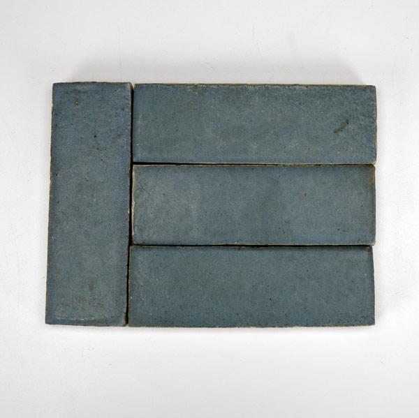 Appraisal: GRUEBY Forty-two field tiles covered in blue-green matte glaze One