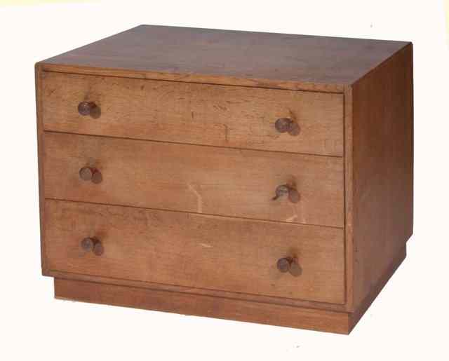 Appraisal: A COTSWOLDS STYLE OAK SMALL CHEST of three drawers with