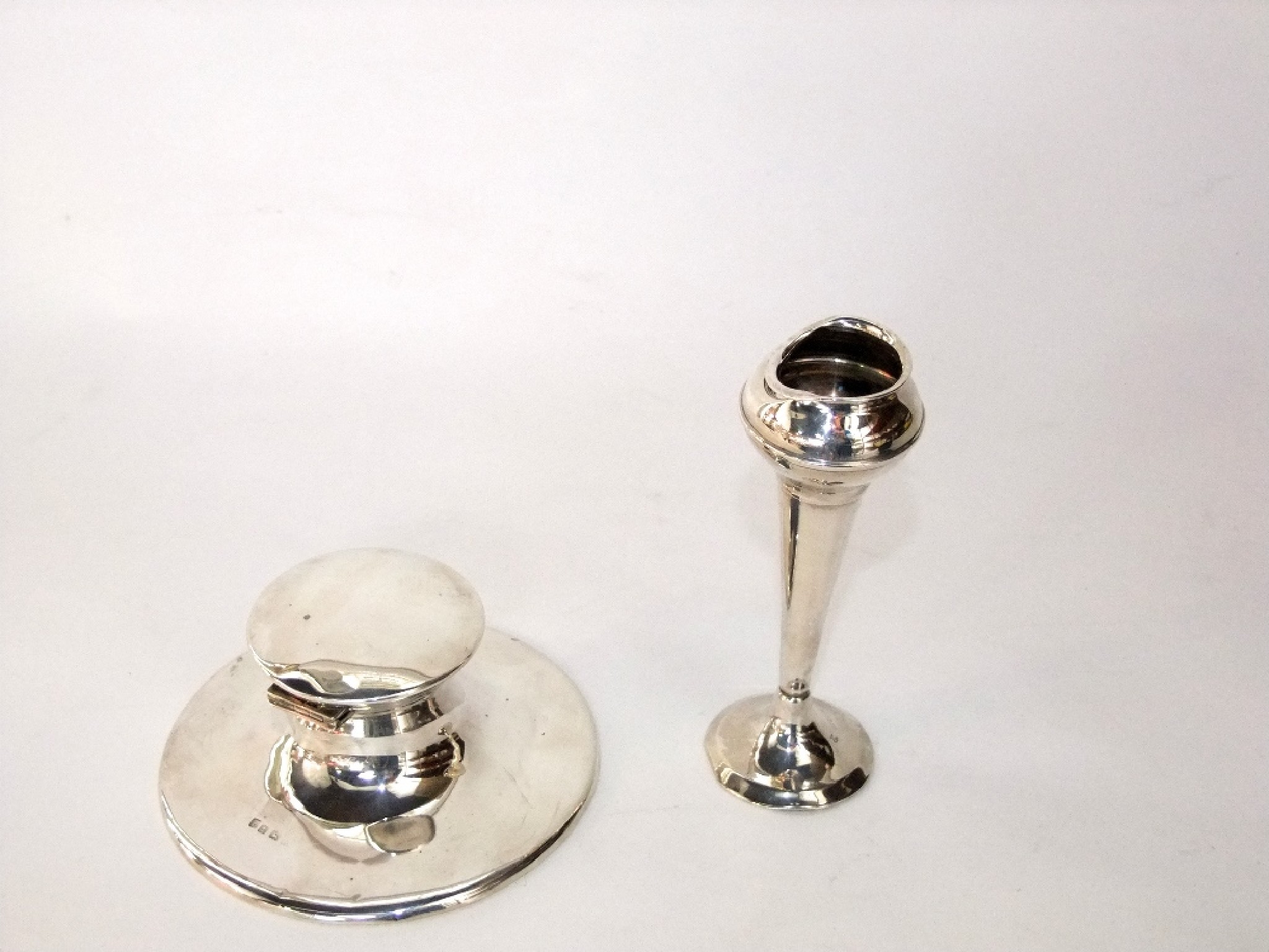 Appraisal: A silver capstain inkwell and a silver bud vase