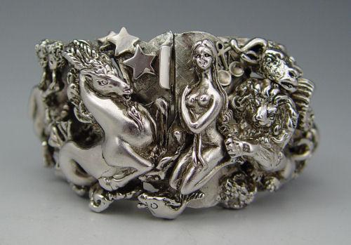 Appraisal: SIGNED TORTOLANI ZODIAC BRACELET Very chunky hinged clamp bracelet showing