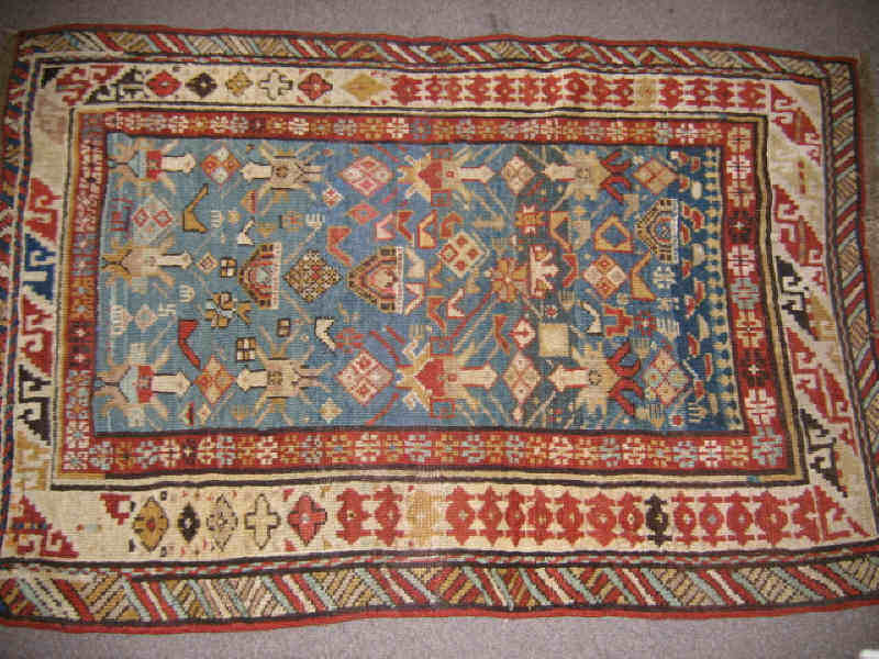 Appraisal: CAUCASIAN TRIBAL THROW RUG The abrashed pale blue field shows