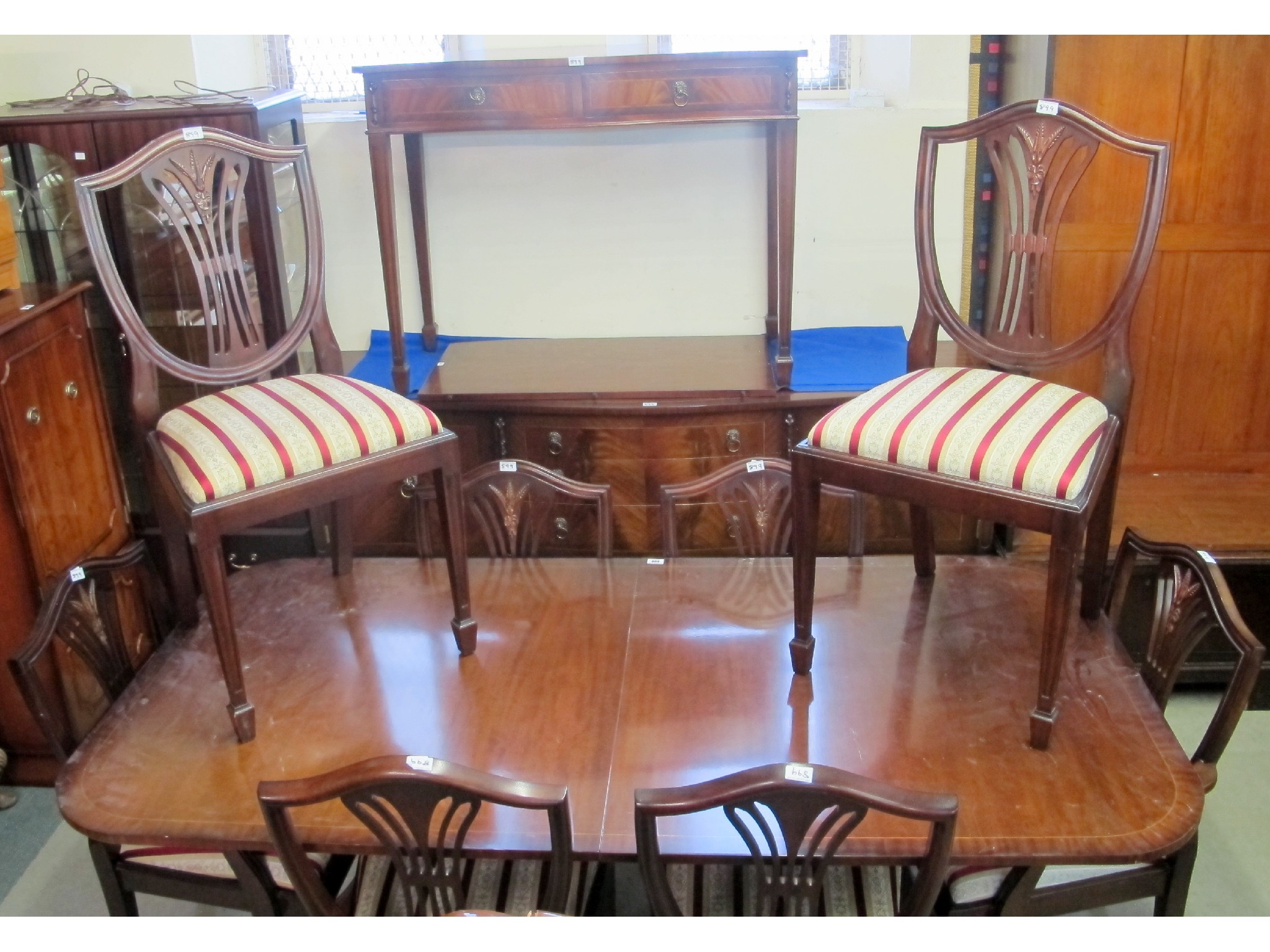 Appraisal: A th Century inlaid mahogany serpentine sideboard and an extending