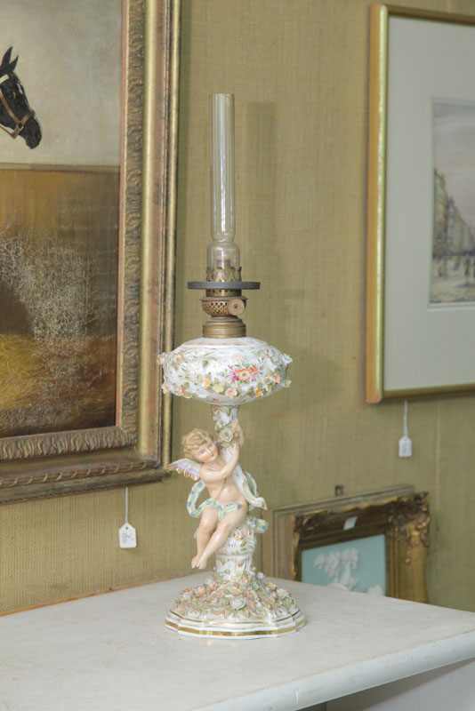 Appraisal: FIGURAL OIL LAMP Attributed to Meissen A winged cherub amongst