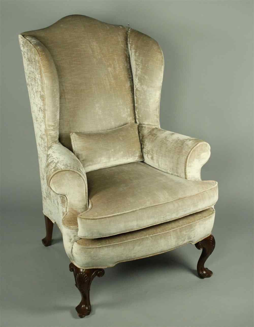 Appraisal: QUEEN ANNE STYLE VELVET UPHOLSTERED WING CHAIR having an arched