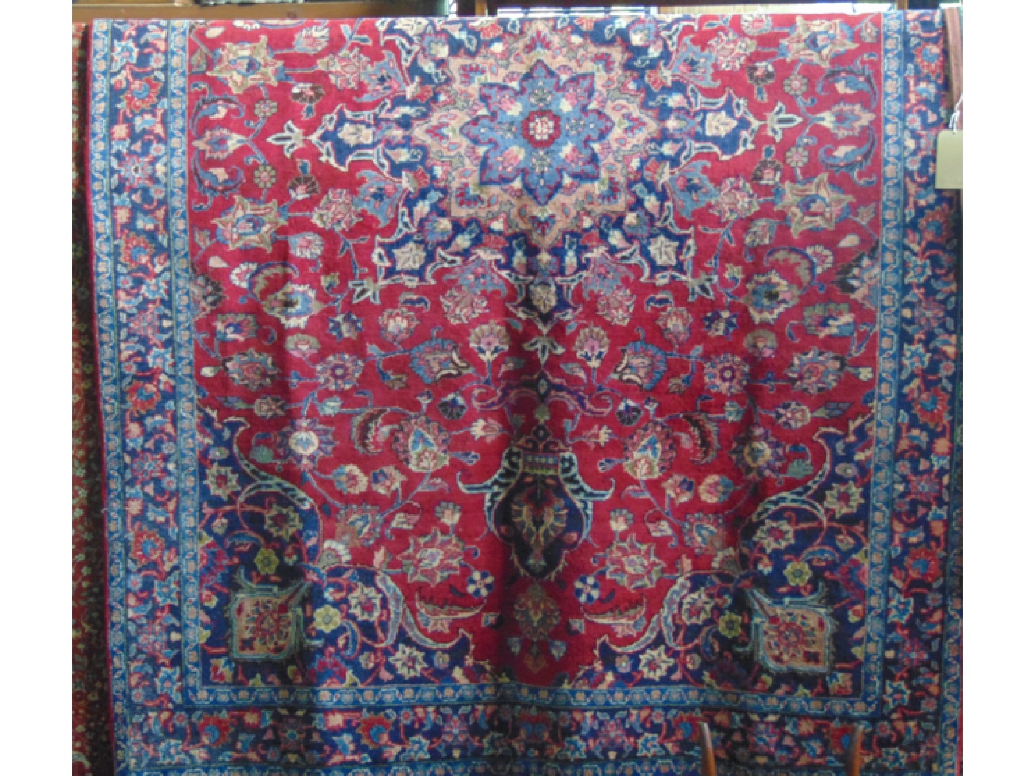 Appraisal: A washed red Afghan carpet with Bukhara design