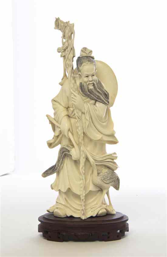 Appraisal: A Carved Ivory Figure depicting the figure with craggy staff