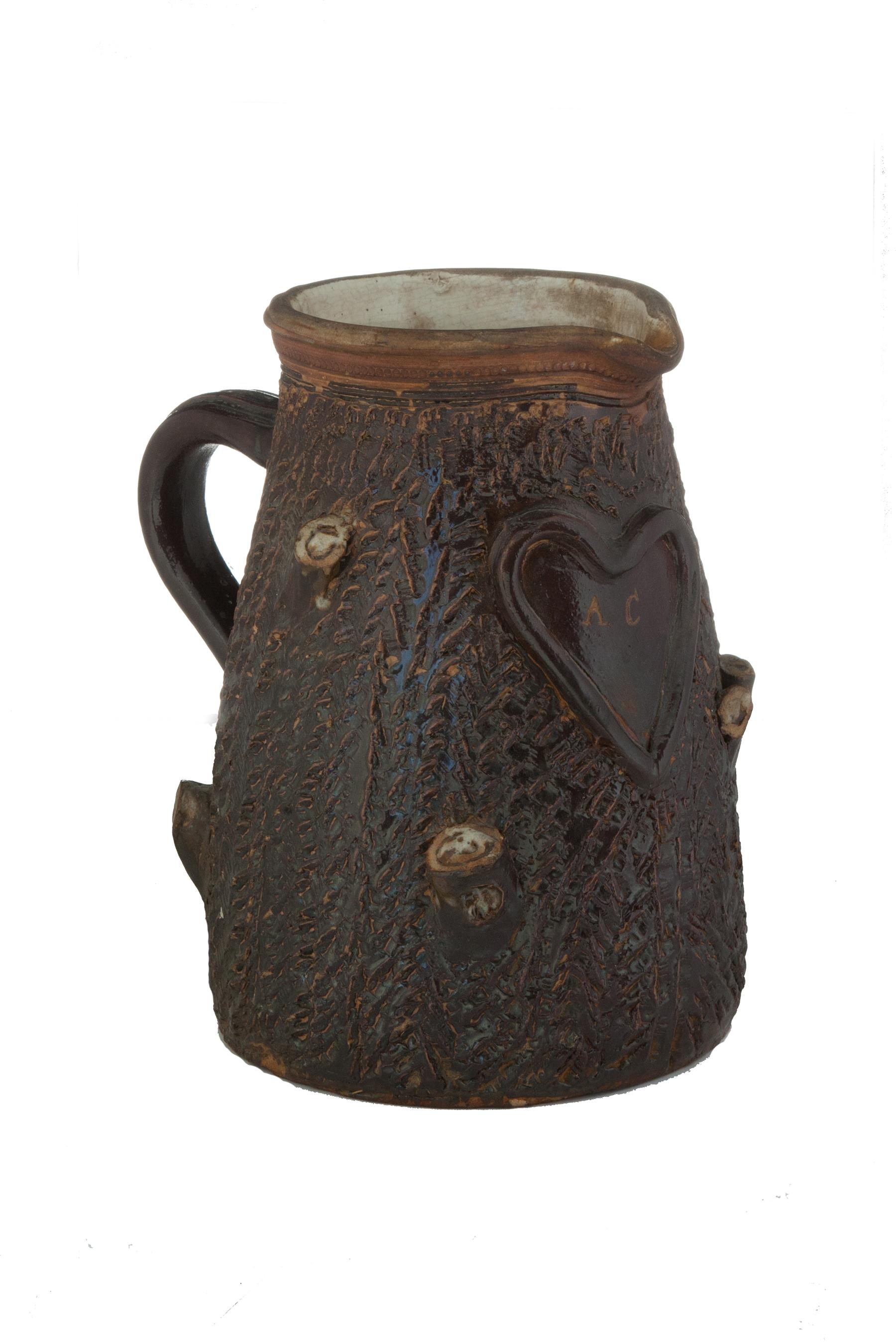 Appraisal: STONEWARE PITCHER American ca Tree-trunk shape coggled rim applied handle