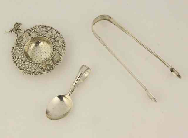 Appraisal: A Dutch silver tea strainer circa a child's silver spoon