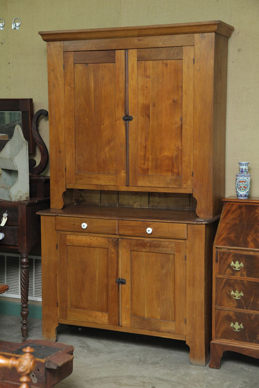 Appraisal: STEPBACK CUPBOARD Walnut and chestnut Thumb molded cornice four paneled