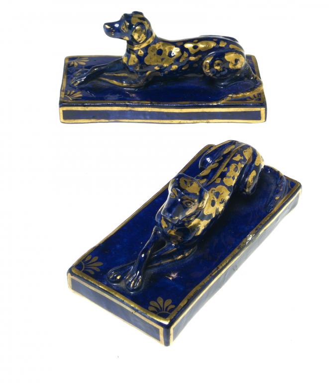 Appraisal: A PAIR OF IRONSTONE COBALT AND GILT MODELS OF RECUMBENT