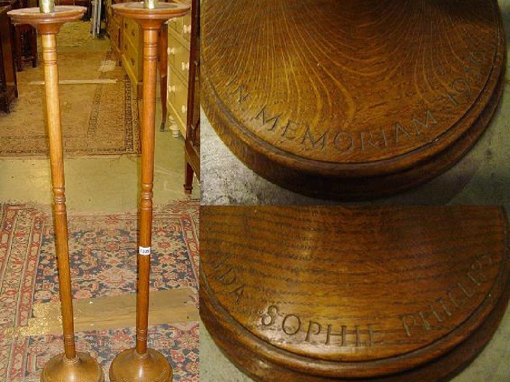 Appraisal: A pair of oak floor standing church candlesticks with simple