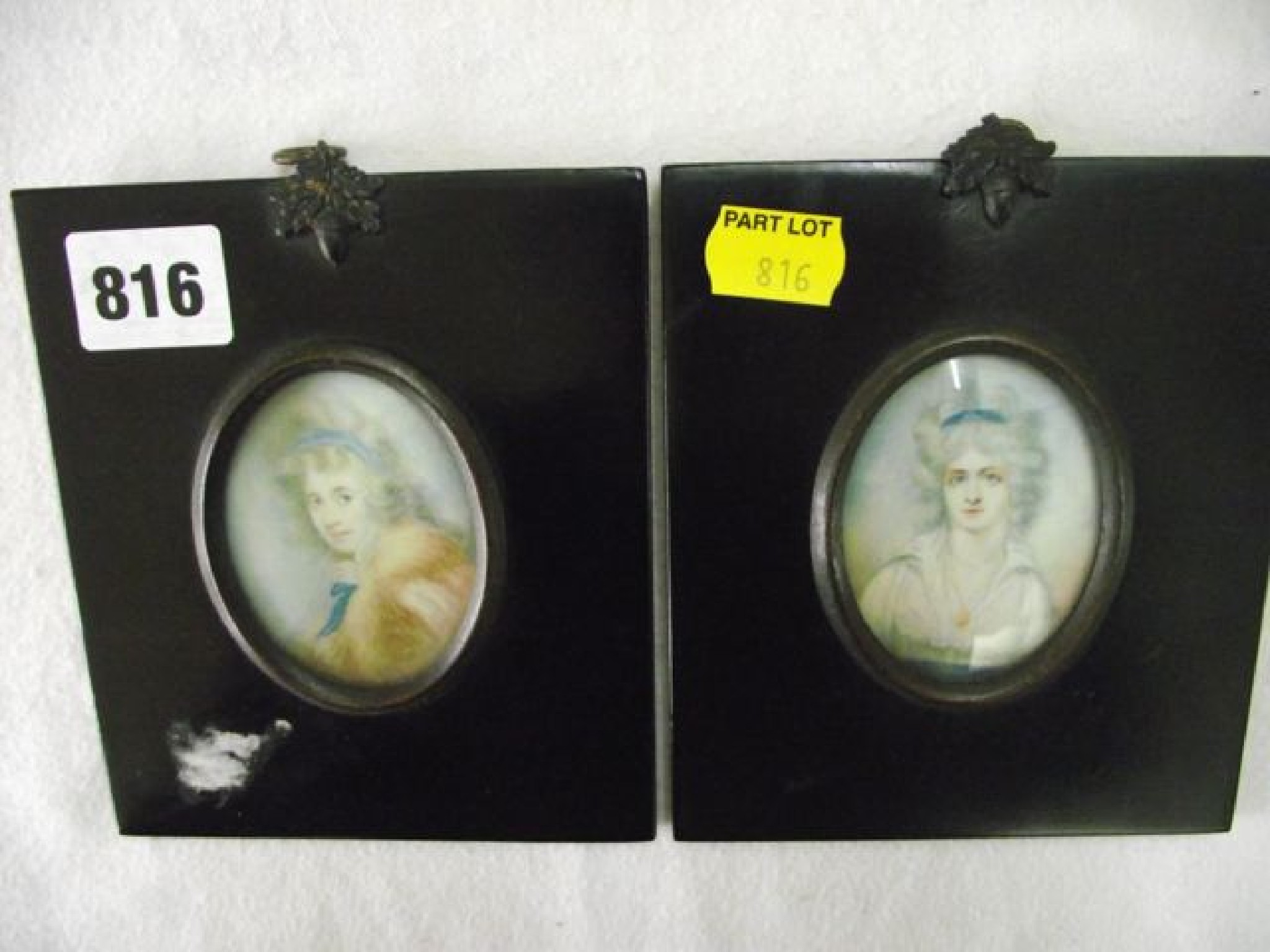 Appraisal: A pair of portrait miniatures showing bust length studies of