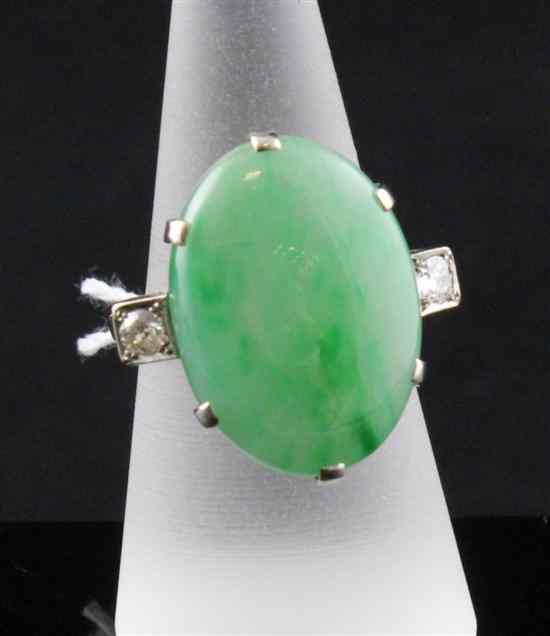 Appraisal: A white gold jadeite and diamond dress ring the oval