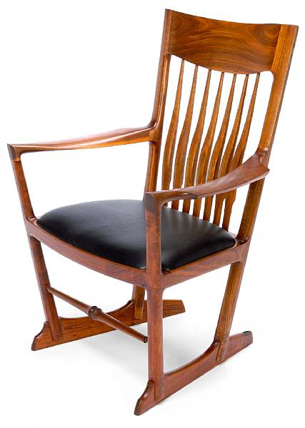 Appraisal: John Nyquist American born Armchair prototype walnut and leather retains