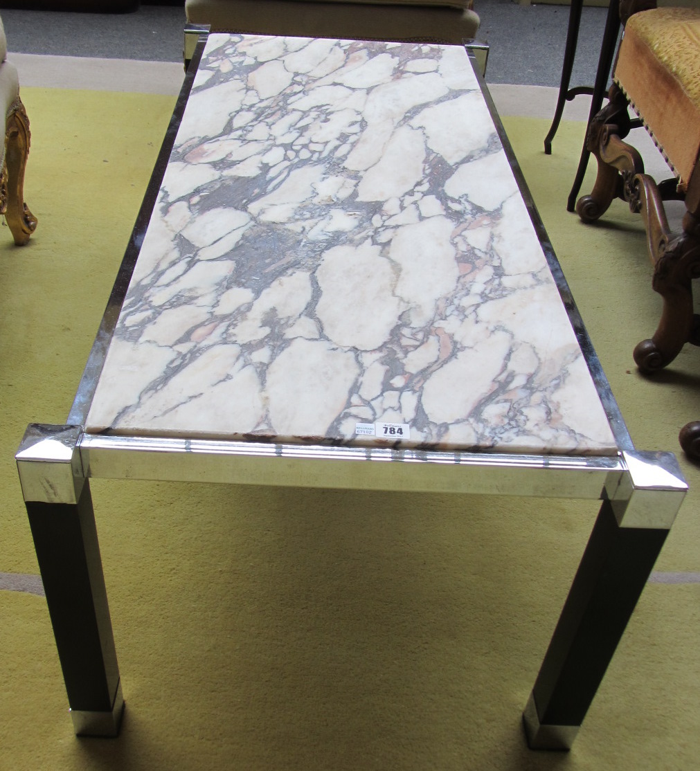 Appraisal: A 's rectangular marble topped coffee table on square chrome