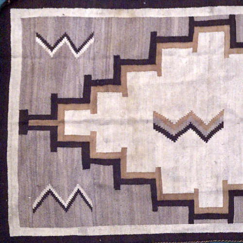 Appraisal: NAVAJO Woven rug with ivory and tan geometric medallion on