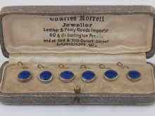 Appraisal: A boxed set of six blue enamel buttons with white