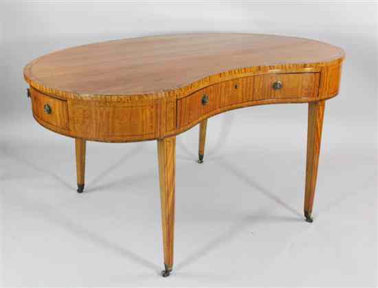 Appraisal: A George III crossbanded satinwood kidney shaped writing table in