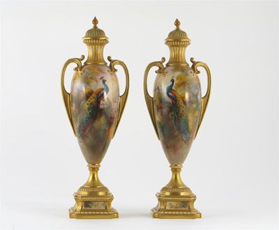 Appraisal: A pair of Royal Worcester vases and covers each decorated