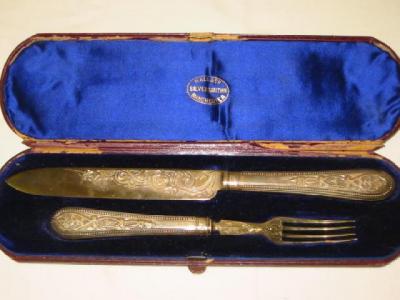 Appraisal: A CASED VICTORIAN CAKE KNIFE AND FORK with foliate chased