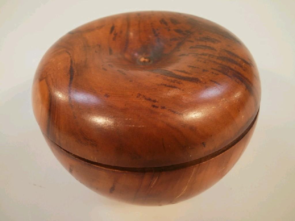 Appraisal: A turned and figured treen box in the form of