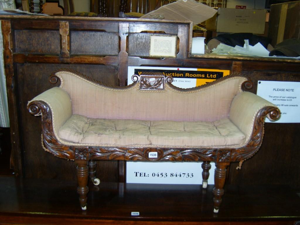 Appraisal: A Regency child's scrolled end sofa in mahogany with fully