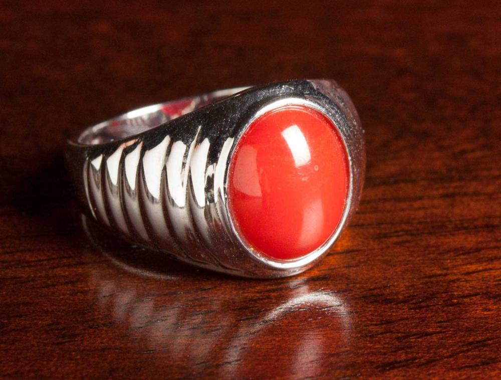 Appraisal: RED CORAL AND FOURTEEN KARAT WHITE GOLD SOLITAIRE RING bezel