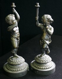 Appraisal: A pair of th century bronze cherub lamp bases