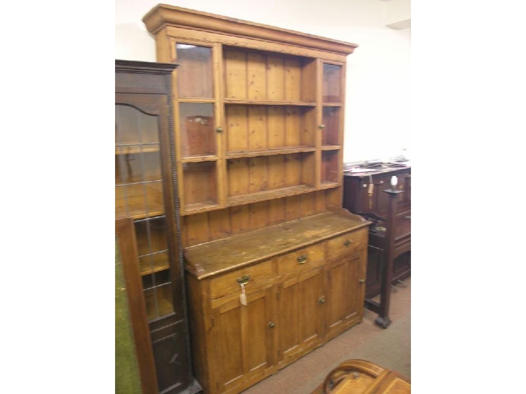 Appraisal: A Victorian waxed pine dresser three over-shelves each flanked by